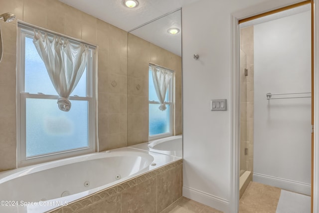 bathroom with plus walk in shower, tile patterned floors, and plenty of natural light