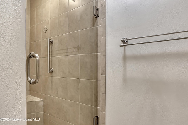 bathroom with a shower with shower door