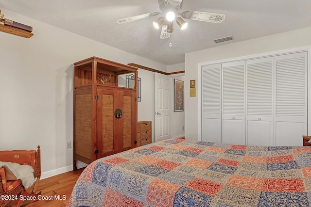 bedroom featuring a closet, ceiling fan, and hardwood / wood-style floors