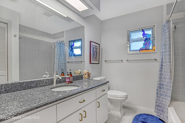 full bathroom featuring tile patterned floors, shower / bathtub combination with curtain, vanity, and toilet