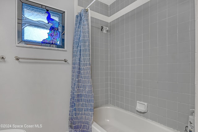 bathroom with shower / bathtub combination with curtain