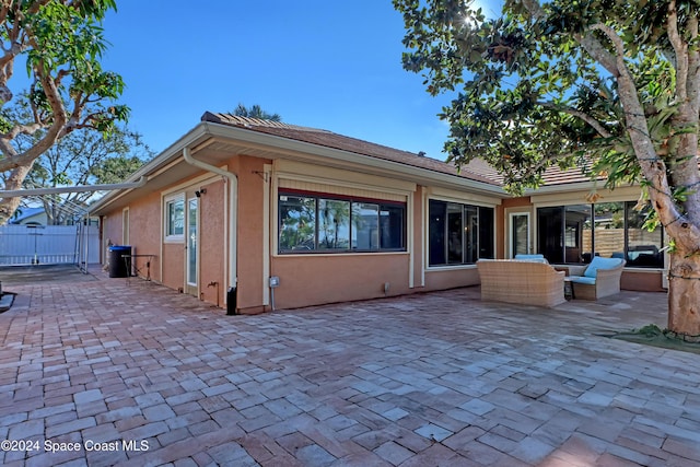 back of house with an outdoor hangout area and a patio area