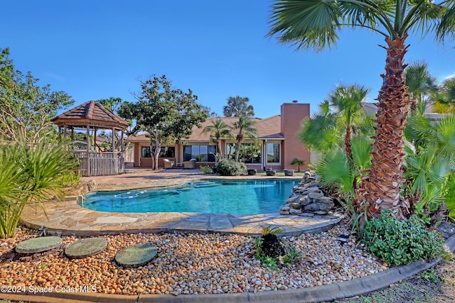 view of swimming pool featuring a gazebo and a patio