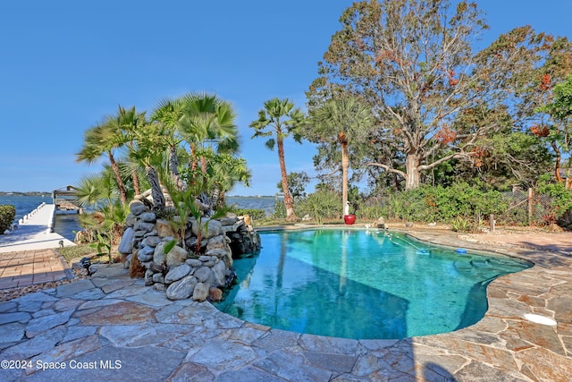 view of swimming pool featuring a water view