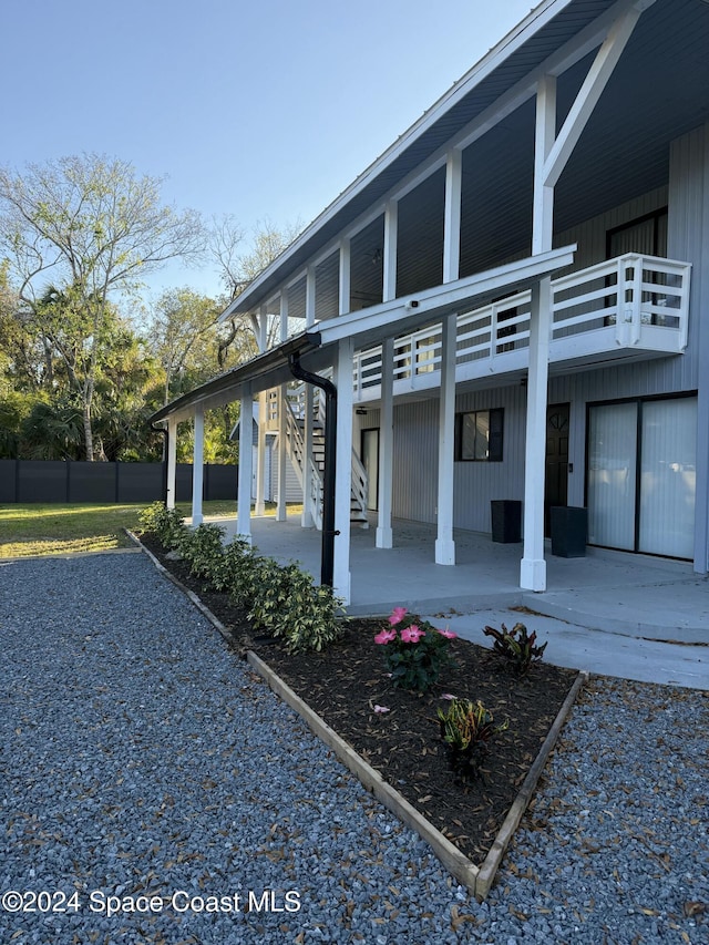 135 Belmont Ave, Cocoa, FL 32927 - view of side of home with stairs and a balcony