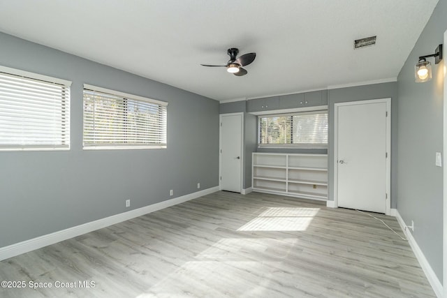 unfurnished bedroom featuring ceiling fan, light hardwood / wood-style floors, and a closet