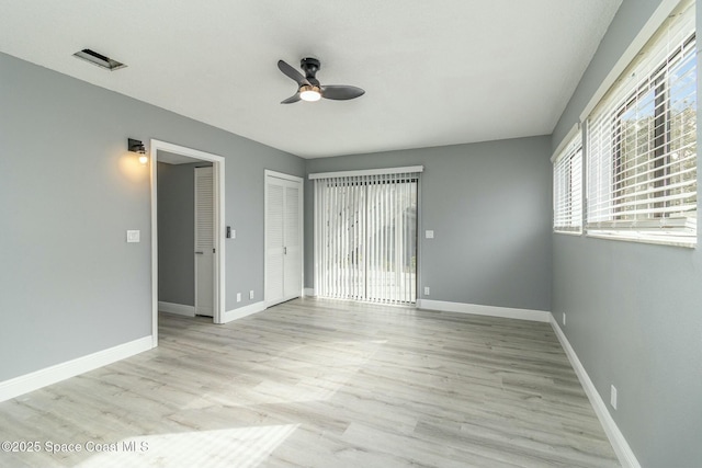 spare room with light hardwood / wood-style flooring and ceiling fan