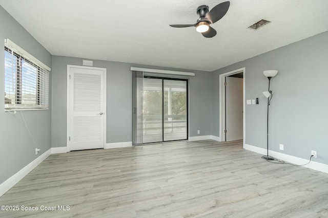 unfurnished bedroom featuring access to exterior, ceiling fan, light hardwood / wood-style flooring, and a textured ceiling