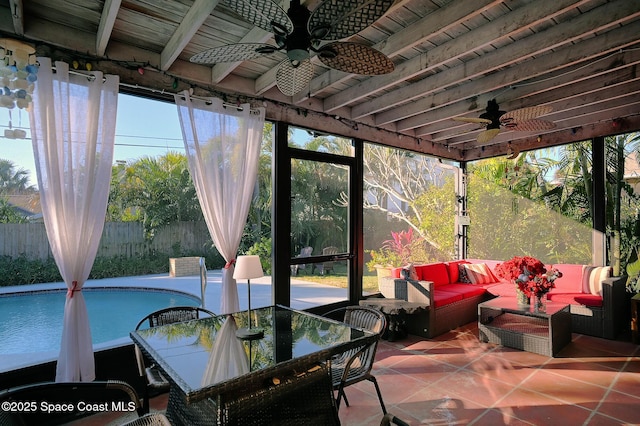 sunroom featuring ceiling fan, wooden ceiling, plenty of natural light, and beam ceiling