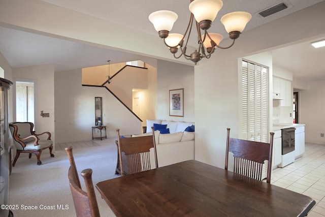 dining area featuring light tile patterned floors and a notable chandelier