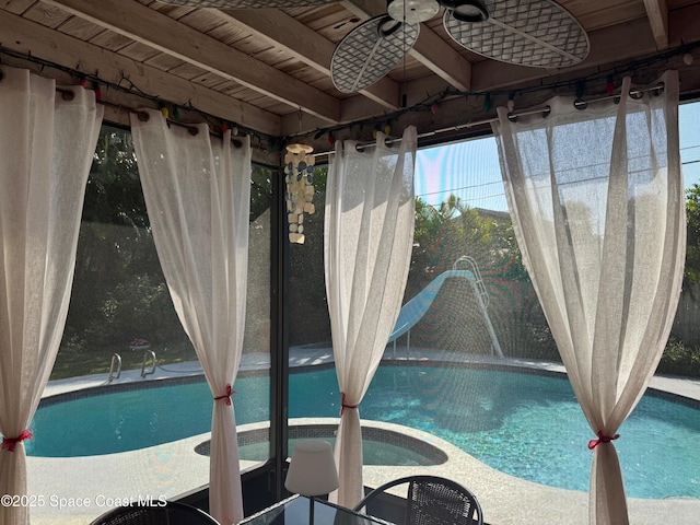 view of pool featuring ceiling fan