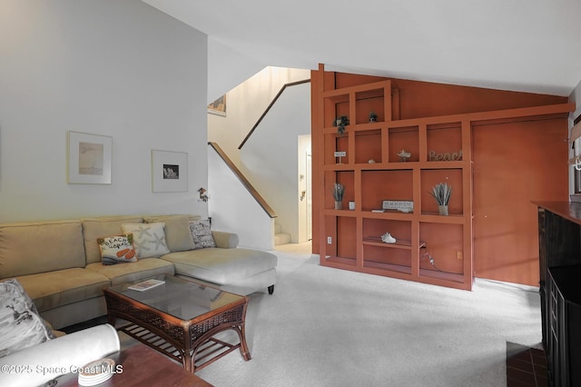 carpeted living room featuring vaulted ceiling