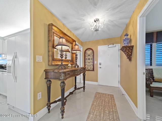 foyer with a chandelier