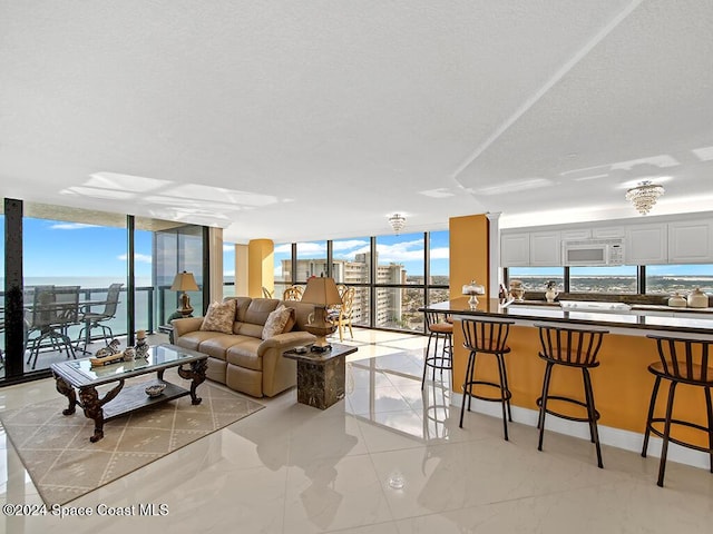 living room with a water view and a wall of windows