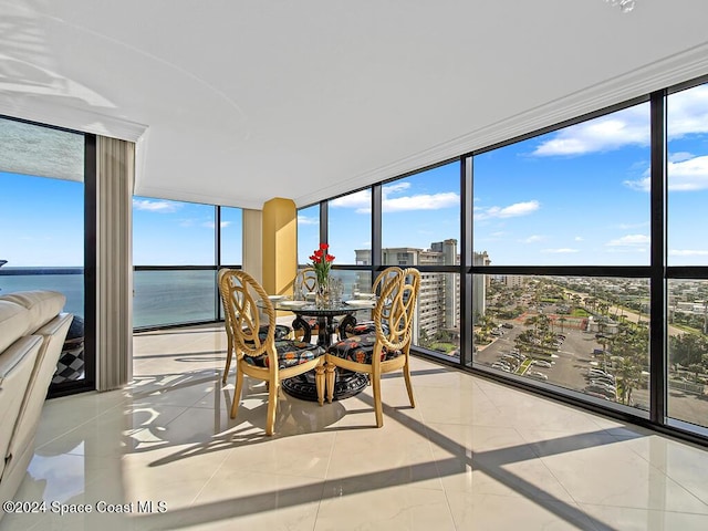 sunroom / solarium with a water view