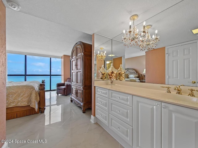 bathroom featuring floor to ceiling windows, a water view, and a textured ceiling