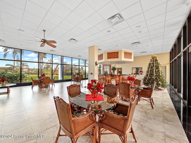 dining area featuring floor to ceiling windows and ceiling fan