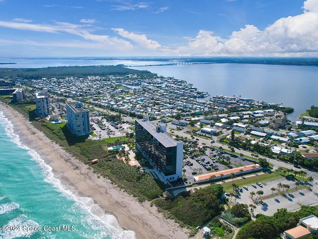 drone / aerial view with a water view and a view of the beach