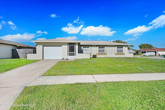 ranch-style home with a garage and a front lawn