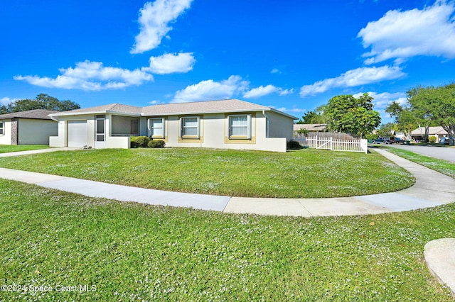 ranch-style house featuring a garage and a front yard