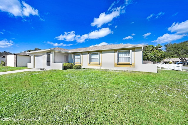 single story home featuring a garage and a front lawn