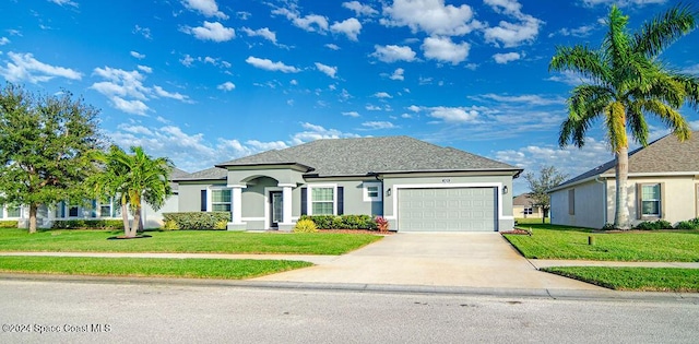 view of front of house with a front yard and a garage