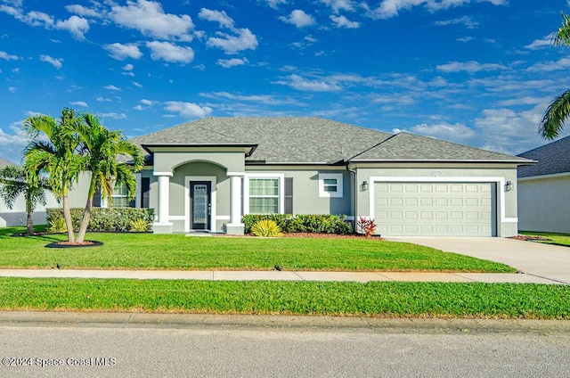 view of front of home featuring a garage and a front yard