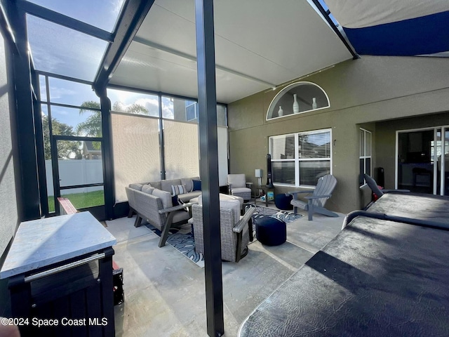 view of patio / terrace featuring glass enclosure and an outdoor living space