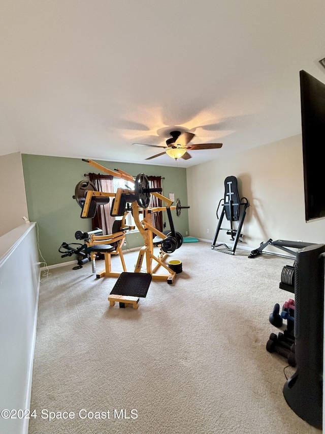 workout room with carpet flooring, a ceiling fan, and baseboards