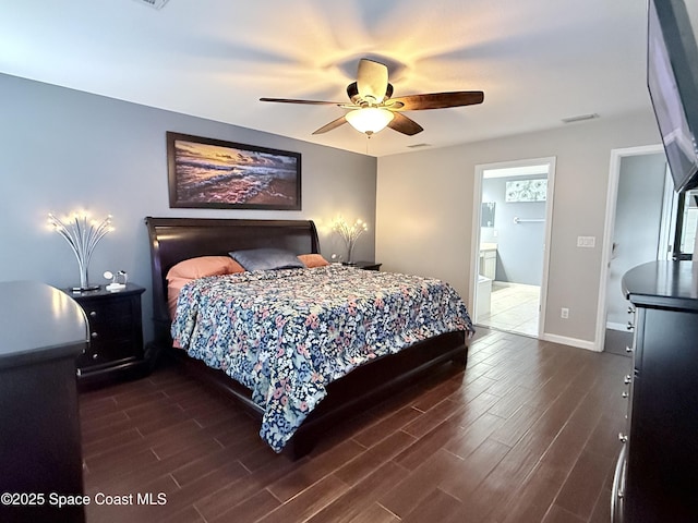 bedroom with baseboards, visible vents, and wood finished floors