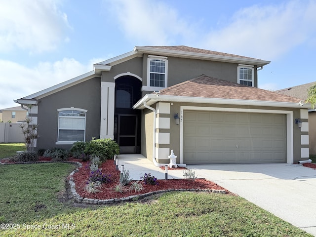 traditional home with a garage, concrete driveway, roof with shingles, stucco siding, and a front lawn