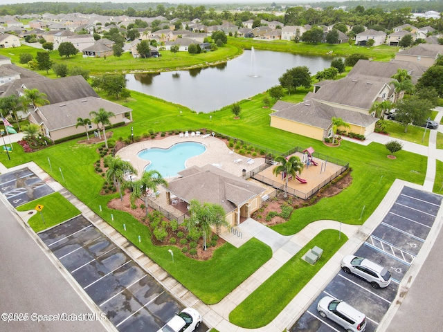 drone / aerial view featuring a water view and a residential view