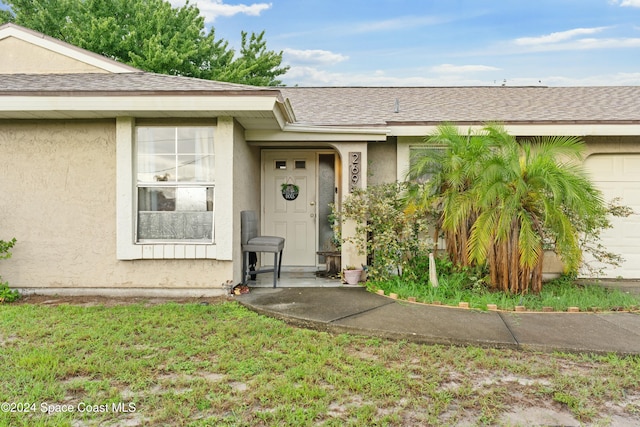 entrance to property with a yard