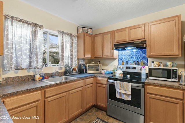 kitchen with a textured ceiling, stainless steel electric range oven, and sink