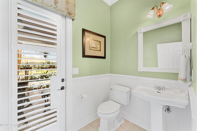 bathroom featuring sink, toilet, and tile patterned flooring