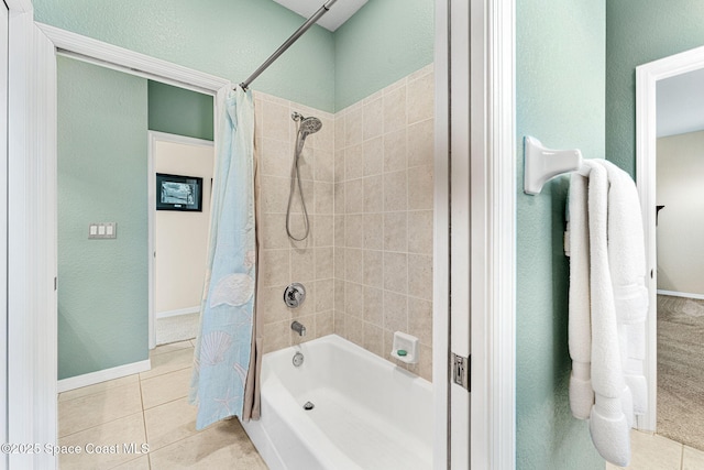 bathroom with tile patterned flooring and shower / bath combination with curtain