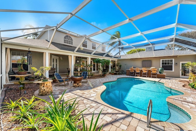 view of swimming pool with a lanai and a patio