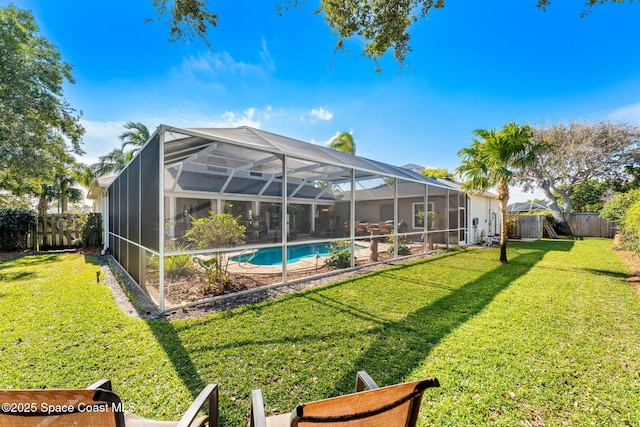 view of yard with a fenced in pool and glass enclosure