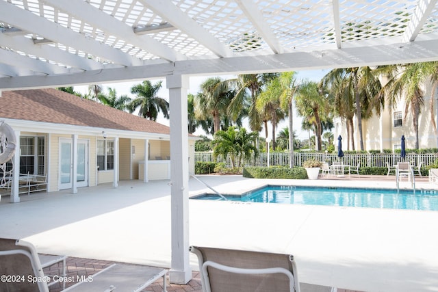 view of swimming pool with a pergola and a patio