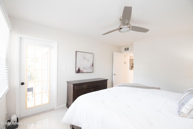 tiled bedroom featuring ceiling fan