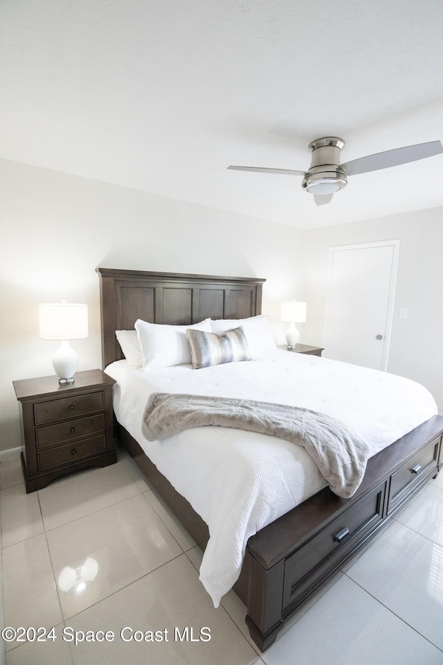 bedroom featuring light tile patterned floors and ceiling fan