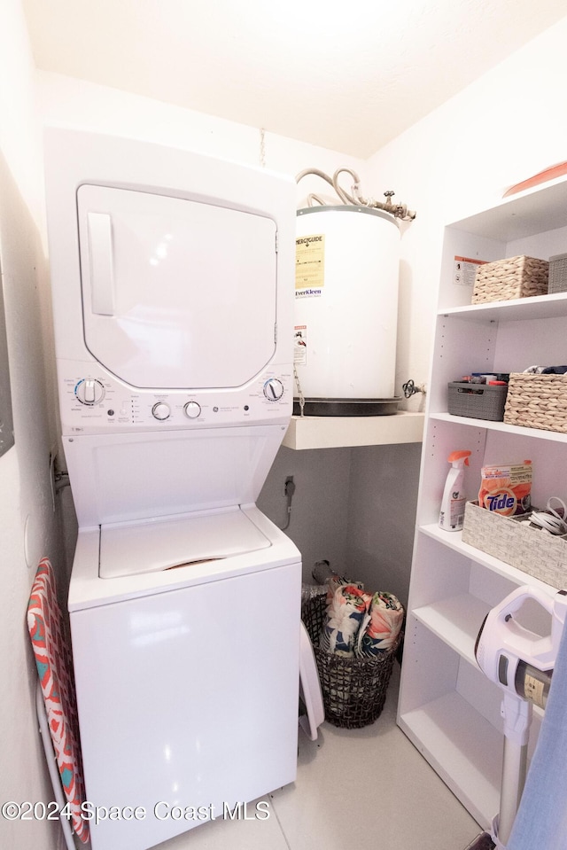 clothes washing area with stacked washer / drying machine and electric water heater