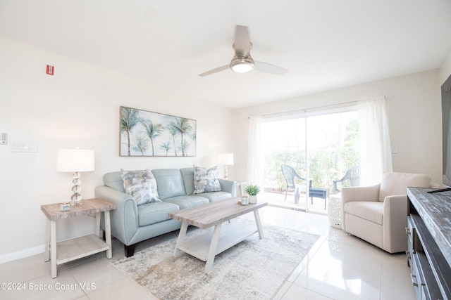 living room with ceiling fan and light tile patterned flooring