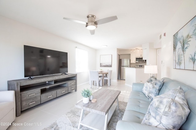 living room with ceiling fan and light tile patterned floors