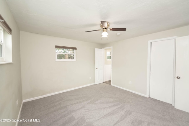 unfurnished bedroom with ceiling fan and carpet floors