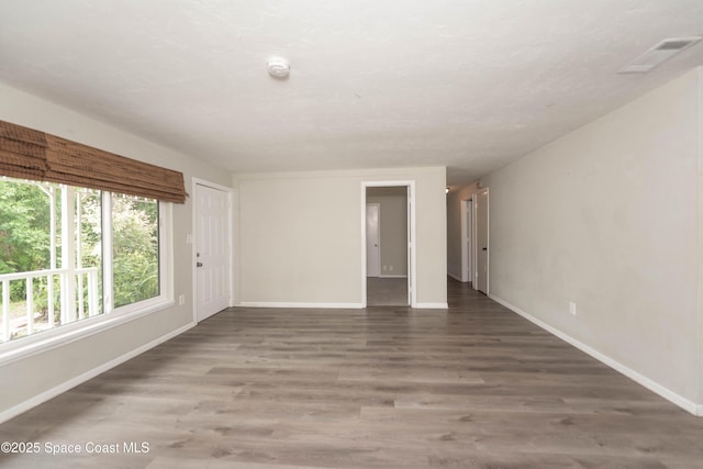 unfurnished room featuring dark wood-type flooring