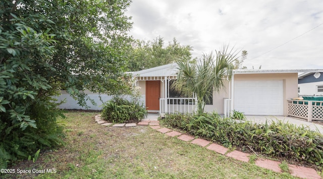 view of front of house with a front yard and a garage