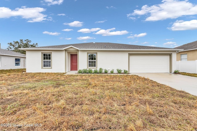 ranch-style home featuring a front lawn and a garage