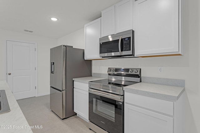 kitchen with white cabinetry and appliances with stainless steel finishes