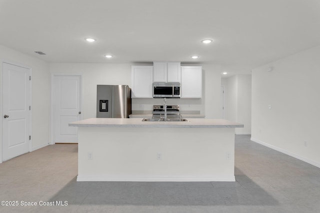 kitchen with white cabinetry, a center island with sink, stainless steel appliances, and sink